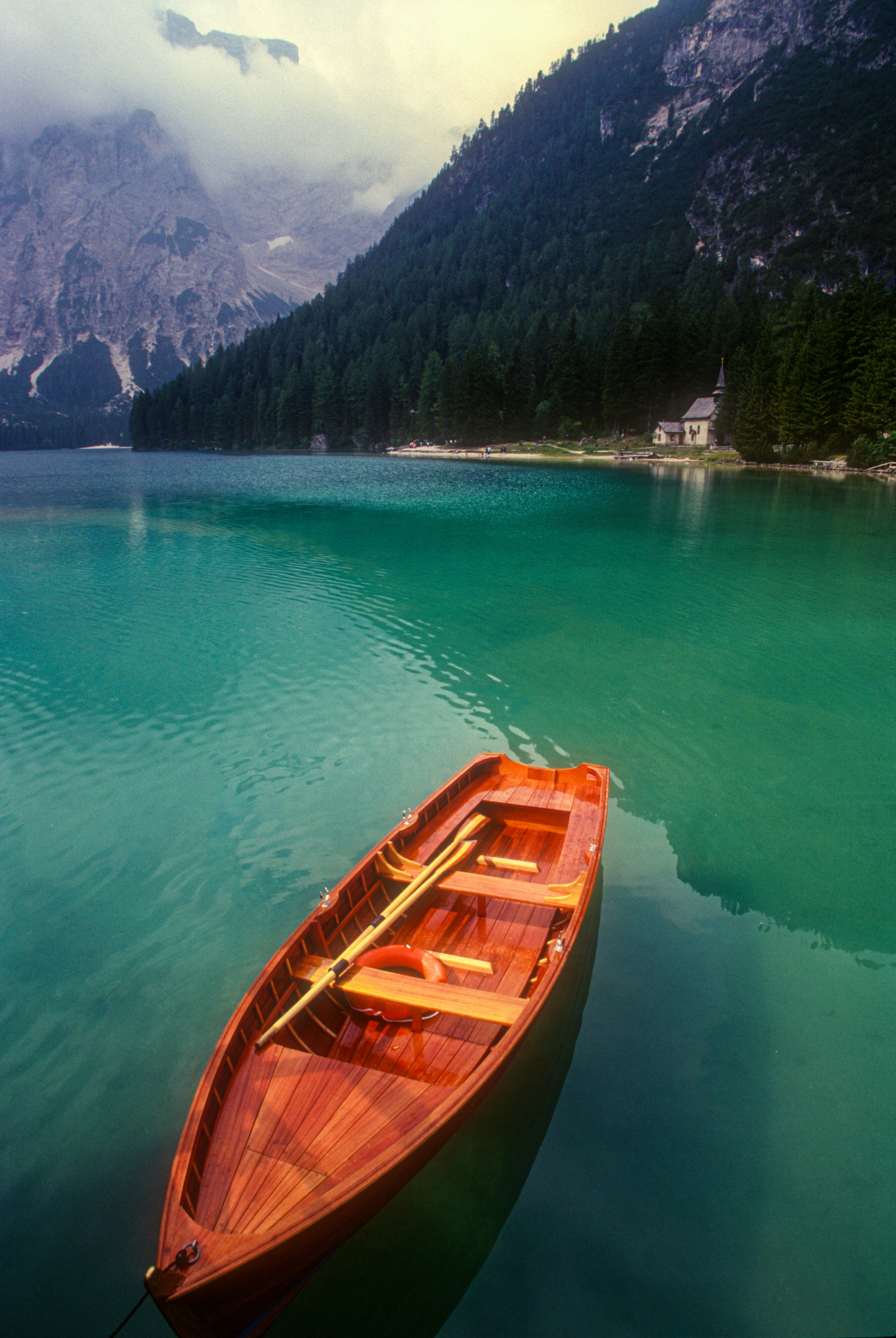 brown wooden boat on body of water during daytime